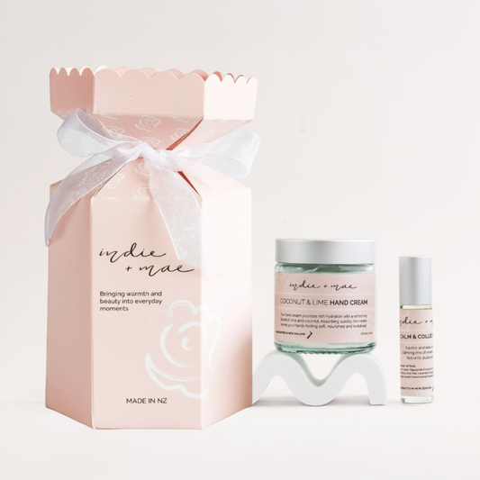 Christmas Cracker with Hand Cream and Aromatherapy Roller next to it - advertising Indie + Mae 