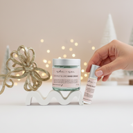 Hand holding an aromatherapy roller, next to a hand cream for Indie + Mae 